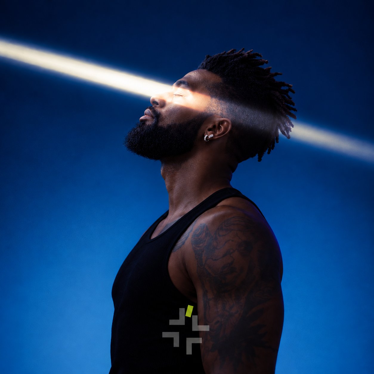 King of Men in profile under a beam of light on a blue background